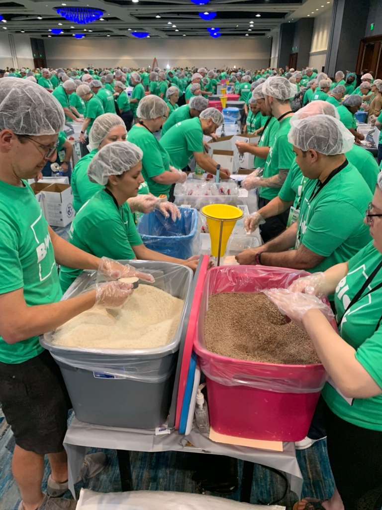 An HR Block employee assembling food packets