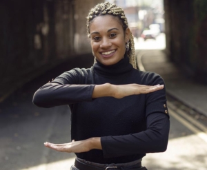 Girl making an equal sign with her arms on International Women's Day.