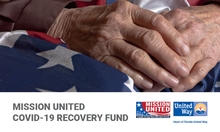 The hands of an elderly Veteran holding an American Flag