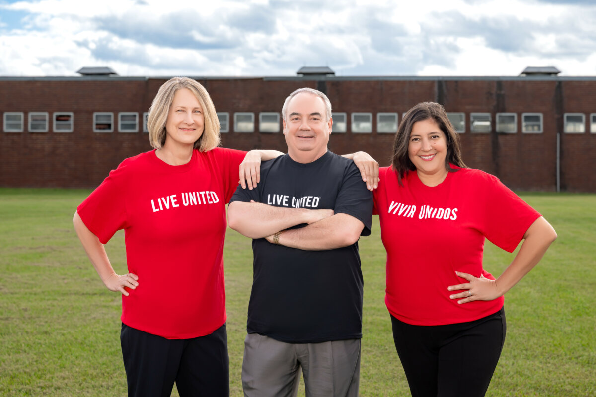 Three leadership team members in Live United shirts