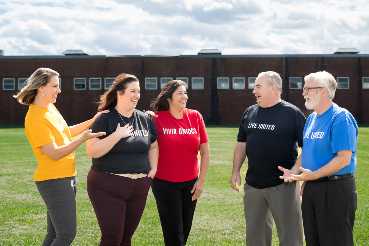 Leadership Team members laughing in Live United shirts