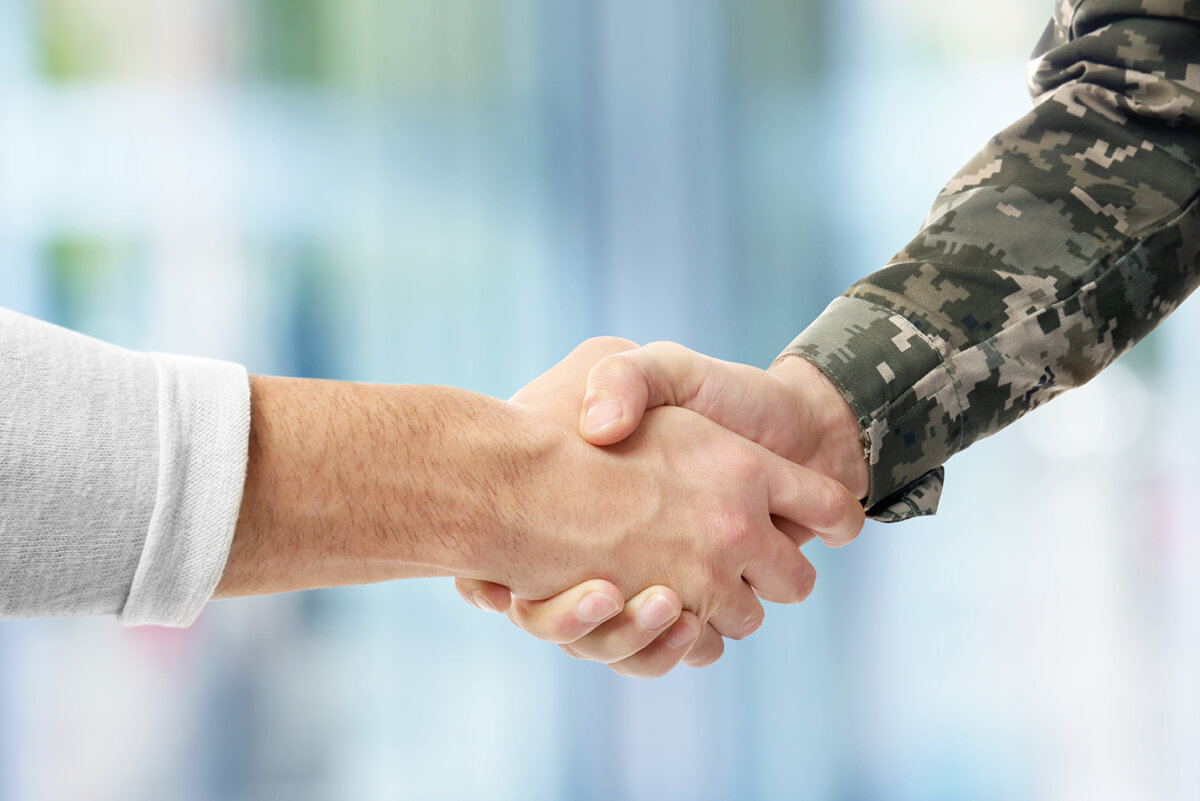 Soldier and civilian shaking hands on white background, closeup