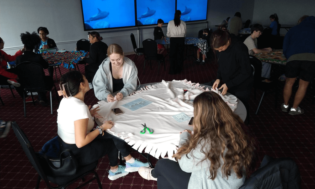 Volunteers making no sew blankets