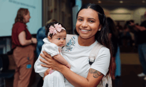 New mom and newborn at HFUW's Community Baby Shower in 2024.